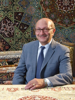 Mansour Yaghoubian, owner of Mansour's Rug Gallery sits surrounded by a few of his favorite Oriental rugs